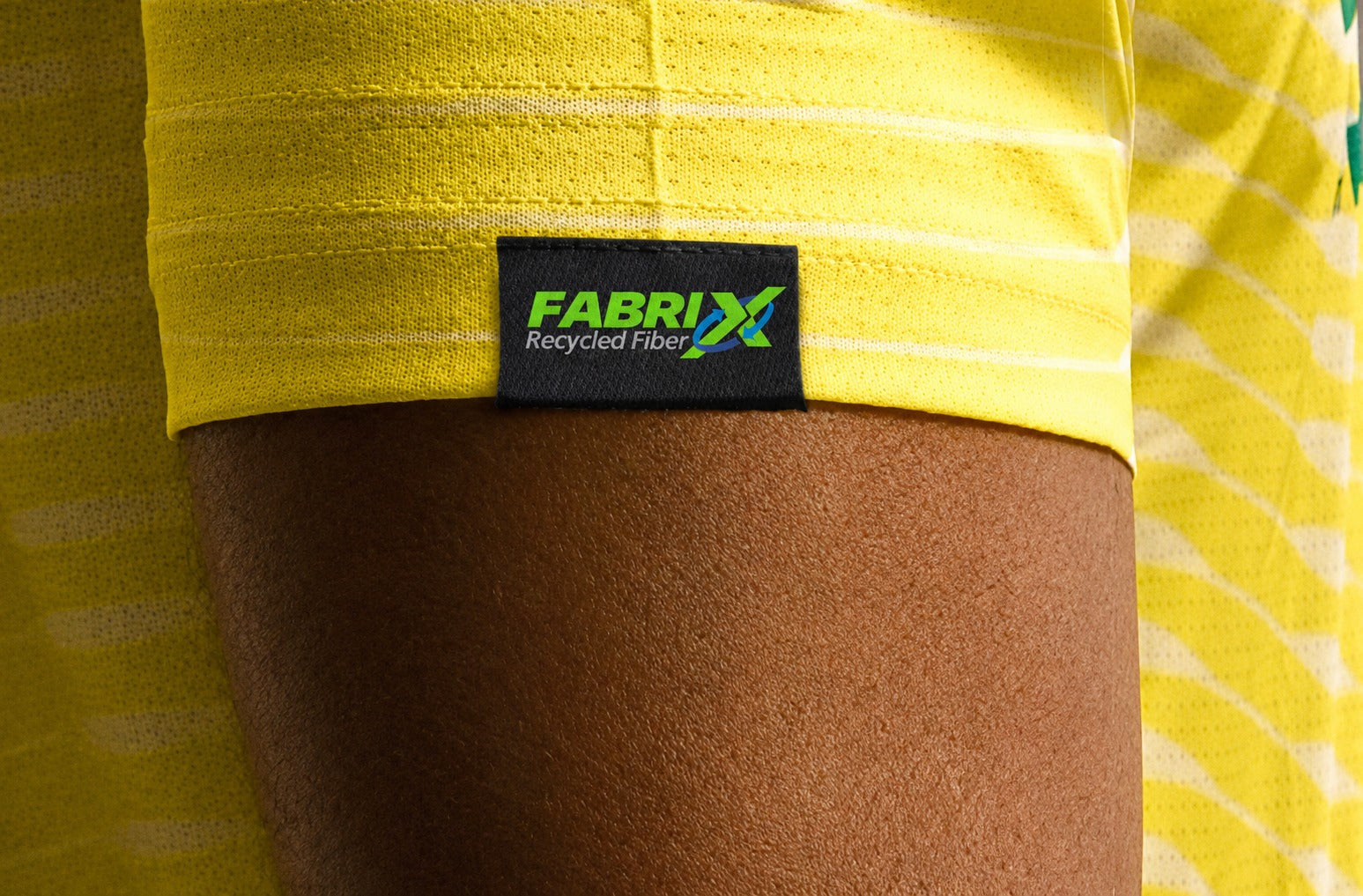 FabriX Recycled Fiber label on a yellow Lexa jersey sleeve